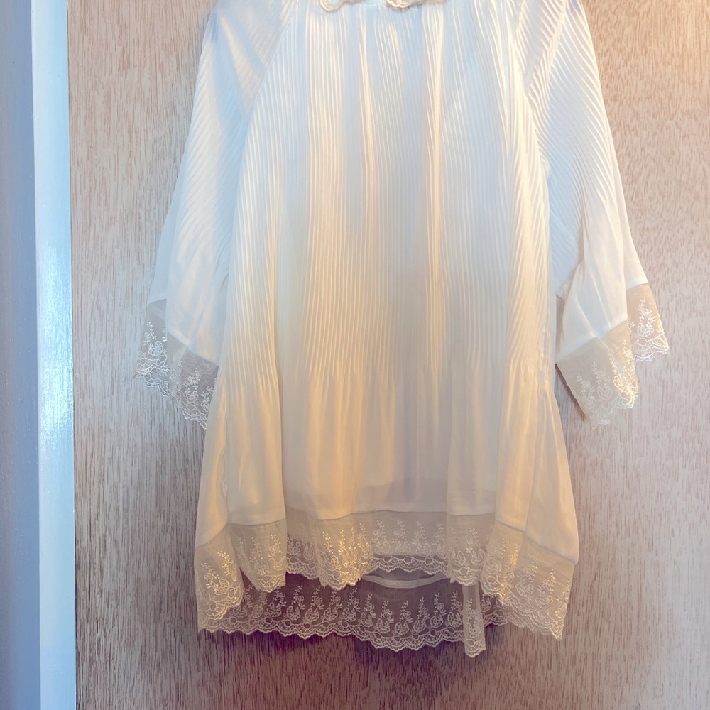 Pleated slip on blouse with lovely lace trim.